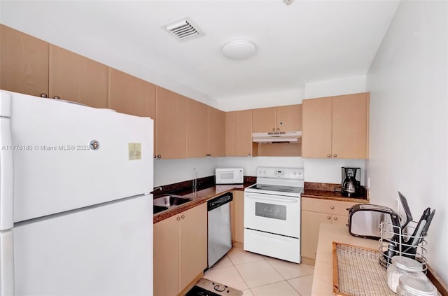 2280 SW 32nd Ave Unit 305, Miami, FL 33145 - kitchen with white appliances, under cabinet range hood, dark countertops, and light tile patterned floors