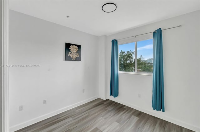 2280 SW 32nd Ave Unit 305, Miami, FL 33145 - spare room with wood finished floors and baseboards