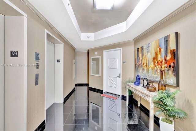 333 Las Olas Way Unit 1007, Fort Lauderdale, FL 33301 - hallway featuring a tray ceiling, baseboards, tile patterned floors, elevator, and crown molding