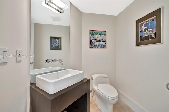 bathroom featuring vanity, toilet, baseboards, tile patterned floors, and visible vents
