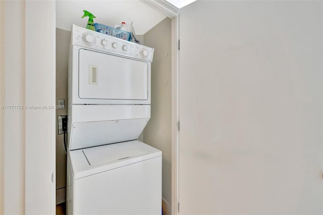 washroom with stacked washer / dryer and laundry area