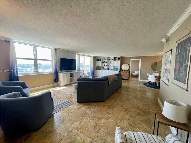 living area with baseboards, a textured ceiling, and crown molding