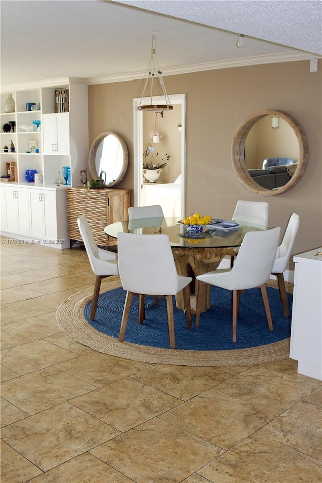 dining area with ornamental molding and a textured ceiling
