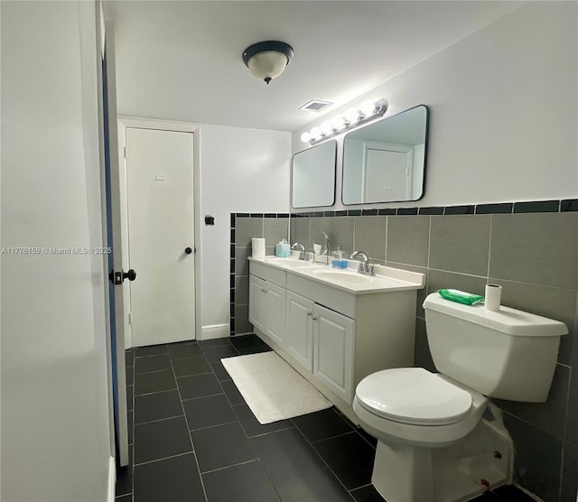 437 Golden Isles Dr Unit 9B-C, Hallandale Beach, FL 33009 - full bath with double vanity, toilet, tile patterned floors, and tile walls