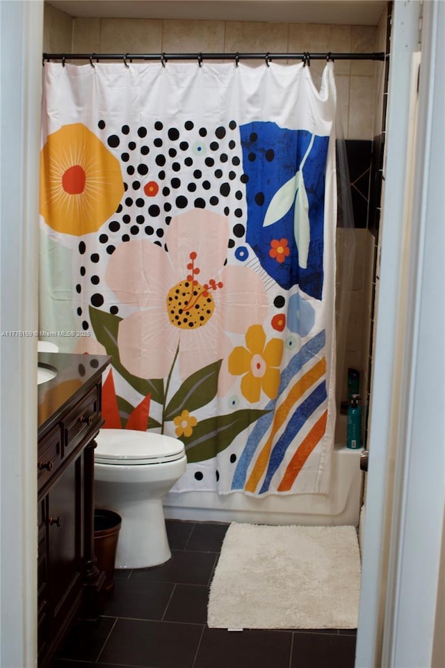 bathroom featuring toilet, shower / bath combo, vanity, and tile patterned flooring
