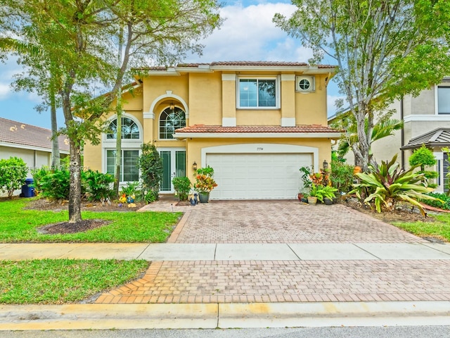 17794 SW 47th St, Miramar, FL 33029 - mediterranean / spanish-style house with an attached garage, stucco siding, decorative driveway, and a tiled roof