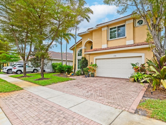 17794 SW 47th St, Miramar, FL 33029 - view of front of home featuring an attached garage, decorative driveway, stucco siding, and a tile roof