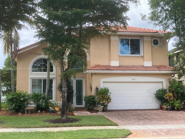 17794 SW 47th St, Miramar, FL 33029 - mediterranean / spanish-style home featuring stucco siding, an attached garage, decorative driveway, and a tile roof