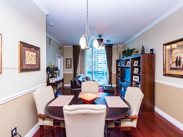 dining area featuring wood finished floors, an inviting chandelier, baseboards, ornamental molding, and visible vents