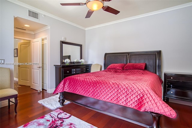 bedroom with a ceiling fan, crown molding, wood finished floors, baseboards, and visible vents