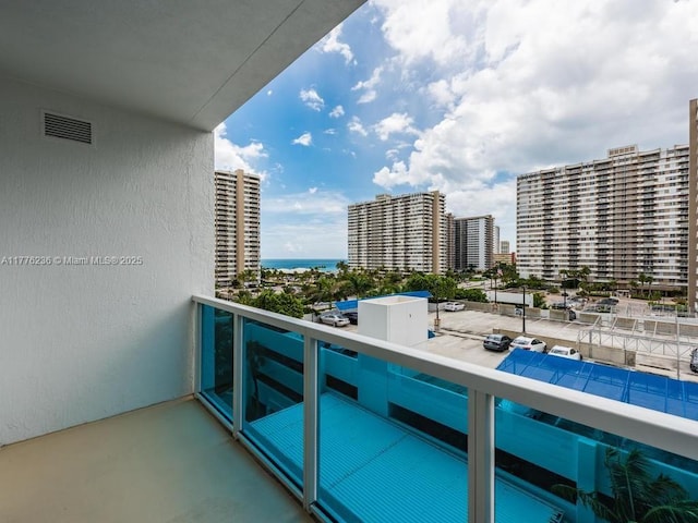 balcony with visible vents and a view of city
