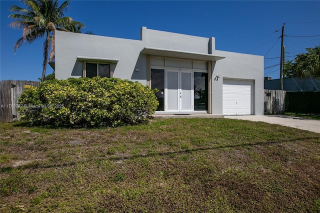 4750 SW 43rd Ave, Dania Beach, FL 33314 - view of front facade featuring a garage, stucco siding, and driveway