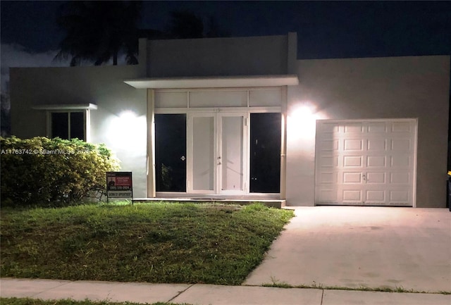 4750 SW 43rd Ave, Dania Beach, FL 33314 - property entrance featuring stucco siding and driveway