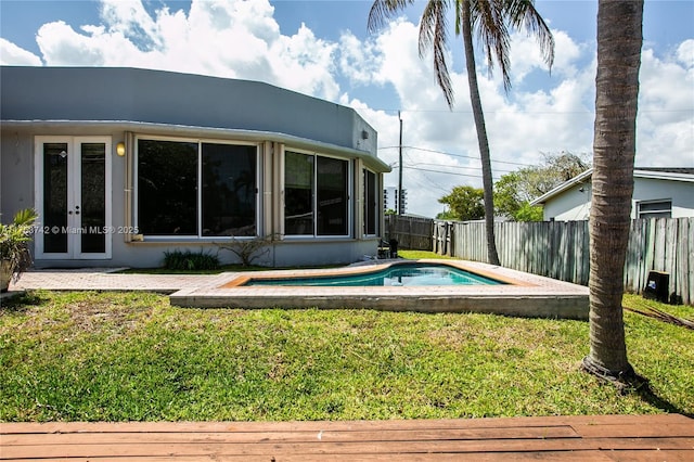 4750 SW 43rd Ave, Dania Beach, FL 33314 - view of swimming pool with a lawn, a fenced in pool, a fenced backyard, and french doors