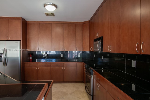 4750 SW 43rd Ave, Dania Beach, FL 33314 - kitchen with stainless steel appliances, backsplash, and brown cabinets