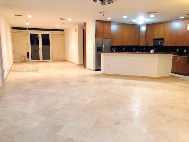 4750 SW 43rd Ave, Dania Beach, FL 33314 - kitchen featuring black microwave, stainless steel fridge with ice dispenser, open floor plan, tasteful backsplash, and recessed lighting