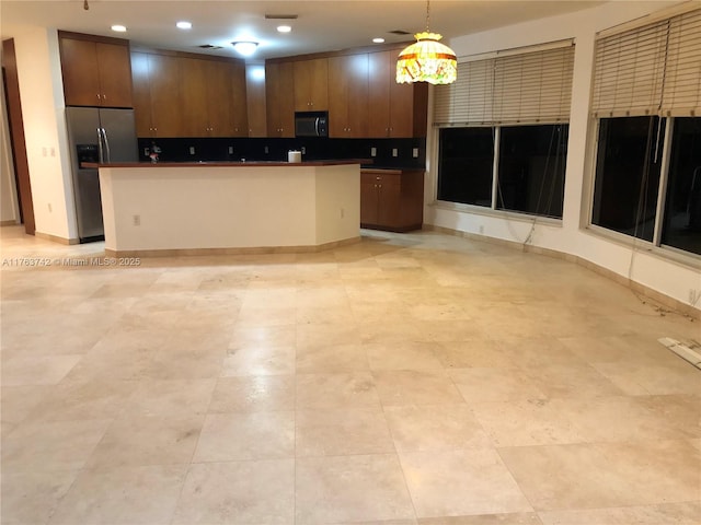 4750 SW 43rd Ave, Dania Beach, FL 33314 - kitchen featuring stainless steel fridge, dark countertops, hanging light fixtures, decorative backsplash, and recessed lighting