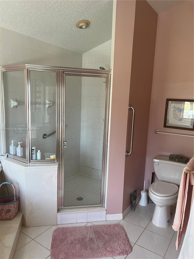 721 Spring Lake Dr, Melbourne, FL 32940 - bathroom featuring a shower stall, a textured ceiling, tile patterned flooring, toilet, and baseboards