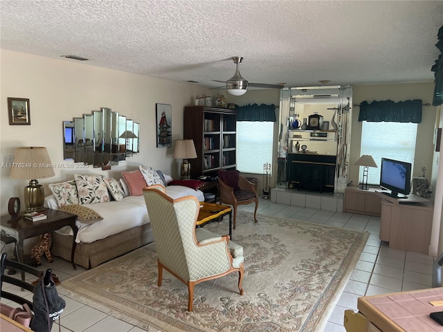 721 Spring Lake Dr, Melbourne, FL 32940 - living room with a textured ceiling, ceiling fan, tile patterned flooring, and visible vents