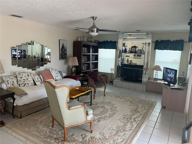 721 Spring Lake Dr, Melbourne, FL 32940 - living room with a ceiling fan, a textured ceiling, tile patterned flooring, and visible vents