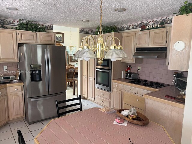 721 Spring Lake Dr, Melbourne, FL 32940 - kitchen featuring light tile patterned floors, appliances with stainless steel finishes, under cabinet range hood, decorative backsplash, and tile counters