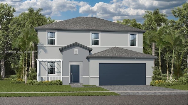 traditional-style house with stucco siding, a garage, a front yard, and decorative driveway