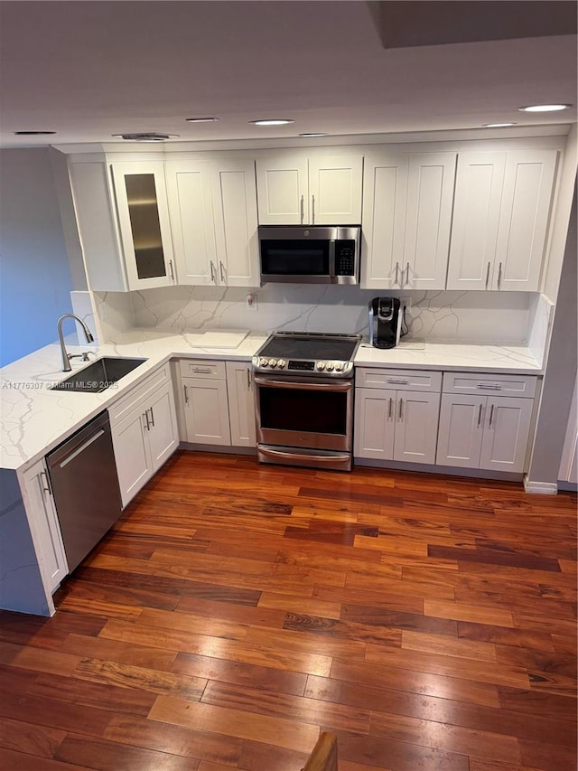 2912 NW 80th Ave, Sunrise, FL 33322 - kitchen with light stone counters, decorative backsplash, appliances with stainless steel finishes, and a sink