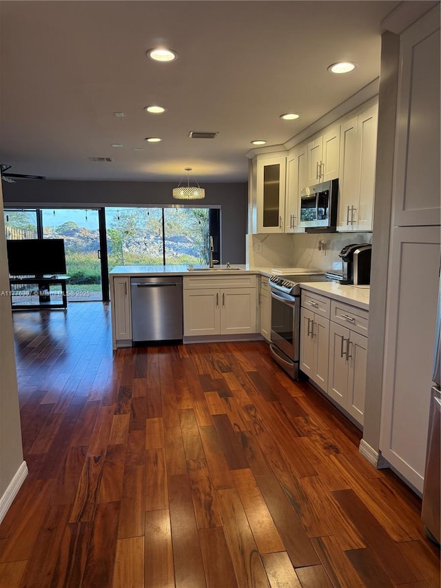 2912 NW 80th Ave, Sunrise, FL 33322 - kitchen with white cabinets, light countertops, visible vents, glass insert cabinets, and appliances with stainless steel finishes