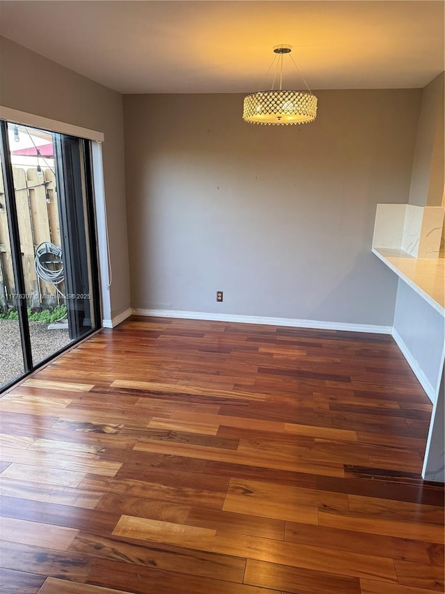 2912 NW 80th Ave, Sunrise, FL 33322 - unfurnished dining area featuring wood finished floors and baseboards