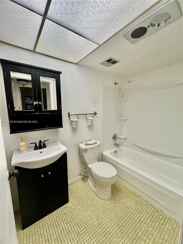 bathroom featuring vanity, shower / washtub combination, baseboards, toilet, and visible vents