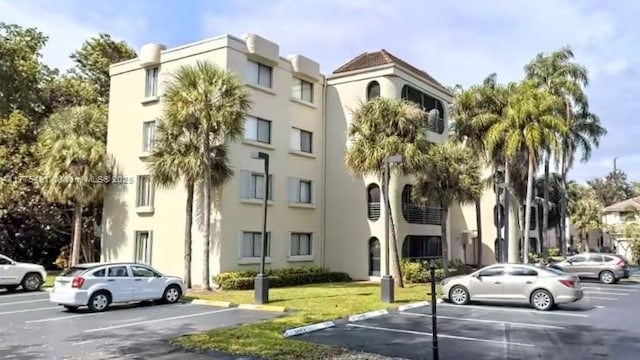 6342 W Longboat Ln W Unit C201, Boca Raton, FL 33433 - view of building exterior with uncovered parking