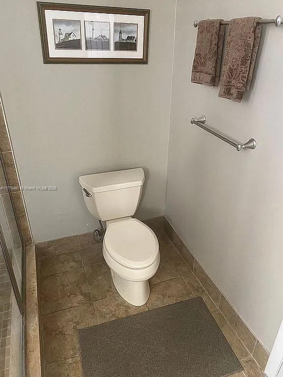 6342 W Longboat Ln W Unit C201, Boca Raton, FL 33433 - bathroom featuring toilet and tile patterned flooring