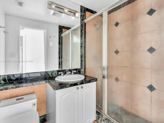 1408 Brickell Bay Dr Unit 816, Miami, FL 33131 - bathroom with a shower stall, vanity, visible vents, and toilet