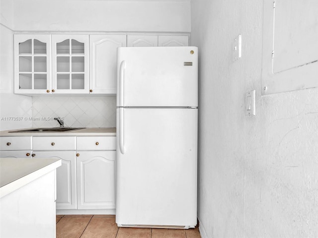 1408 Brickell Bay Dr Unit 816, Miami, FL 33131 - kitchen with a sink, glass insert cabinets, white cabinets, and freestanding refrigerator