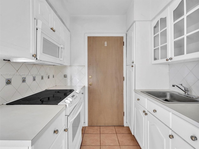 1408 Brickell Bay Dr Unit 816, Miami, FL 33131 - kitchen with white appliances, light countertops, a sink, and light tile patterned floors