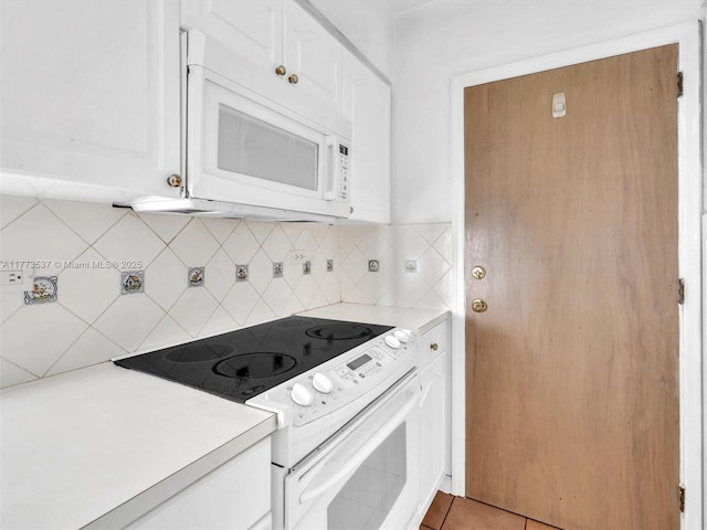 1408 Brickell Bay Dr Unit 816, Miami, FL 33131 - kitchen featuring white cabinets, backsplash, light countertops, and white appliances