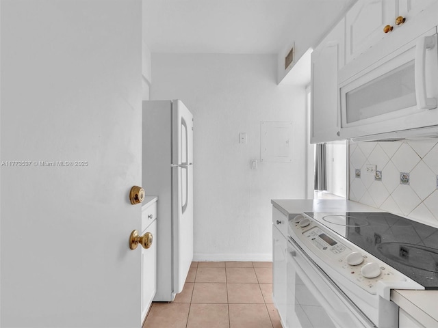 1408 Brickell Bay Dr Unit 816, Miami, FL 33131 - kitchen featuring baseboards, white appliances, light tile patterned floors, backsplash, and white cabinets