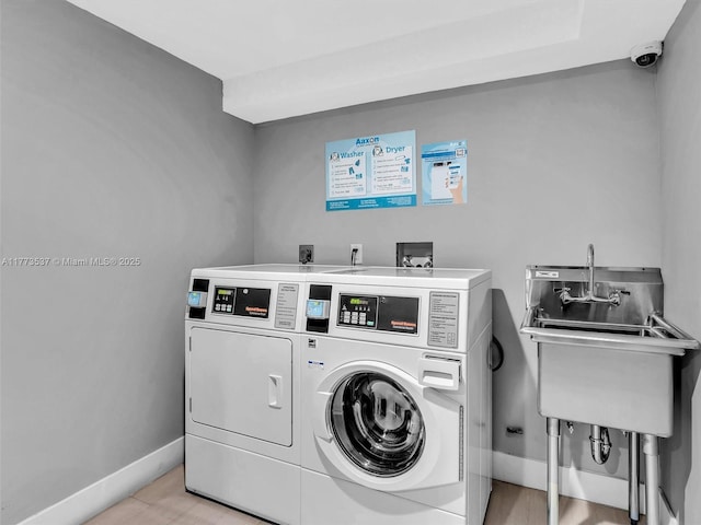 1408 Brickell Bay Dr Unit 816, Miami, FL 33131 - community laundry room with a sink, washer and clothes dryer, and baseboards