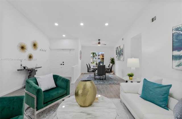 living room featuring lofted ceiling, recessed lighting, baseboards, ceiling fan, and wood finished floors