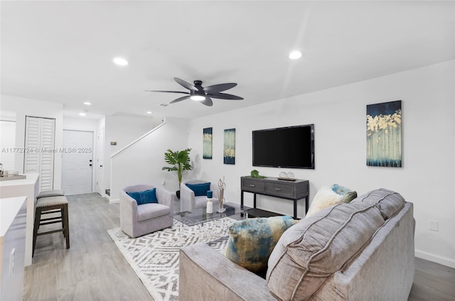 living room featuring stairs, wood finished floors, recessed lighting, and a ceiling fan