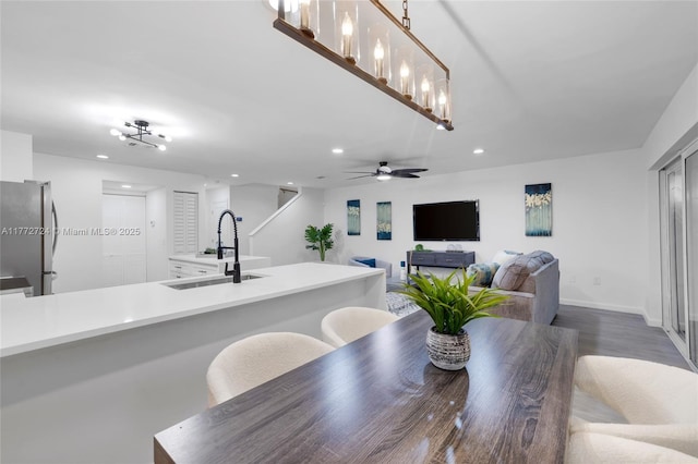dining area with baseboards, dark wood-style flooring, ceiling fan, and recessed lighting