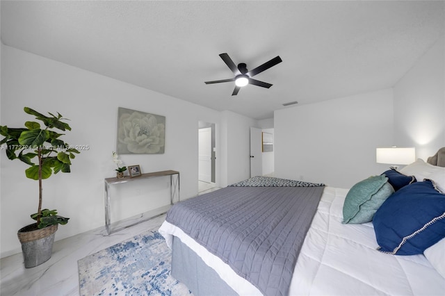 bedroom featuring marble finish floor, visible vents, and ceiling fan