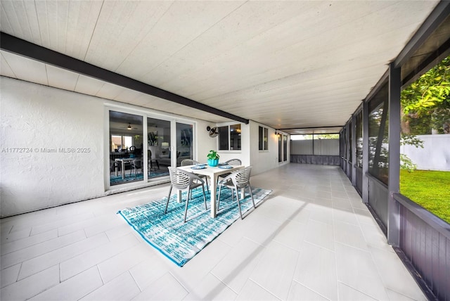 sunroom / solarium featuring outdoor dining area
