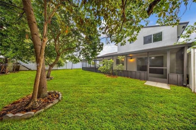 view of yard with a fenced backyard and a sunroom