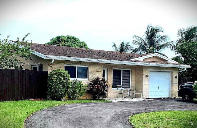3190 NW 66th Dr, Fort Lauderdale, FL 33309 - ranch-style house featuring a garage, brick siding, fence, and asphalt driveway