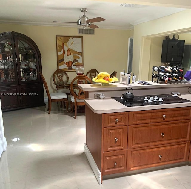 3190 NW 66th Dr, Fort Lauderdale, FL 33309 - kitchen featuring a ceiling fan, crown molding, brown cabinetry, light countertops, and black electric stovetop