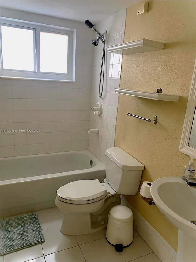 3190 NW 66th Dr, Fort Lauderdale, FL 33309 - bathroom featuring toilet, tile patterned flooring, washtub / shower combination, a textured wall, and a sink