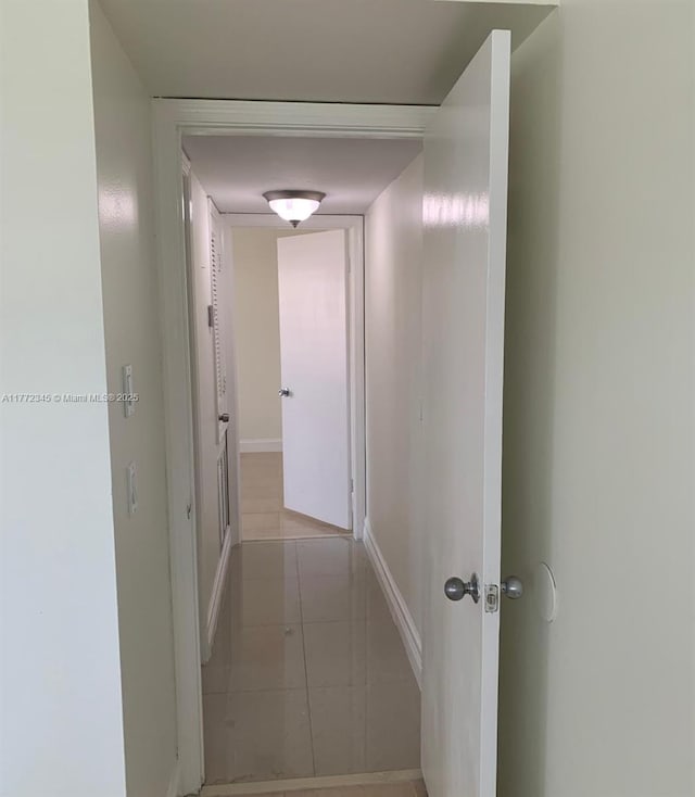 3190 NW 66th Dr, Fort Lauderdale, FL 33309 - hallway featuring baseboards and light tile patterned floors