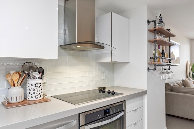 1600 NE 1st Ave Unit 2615, Miami, FL 33132 - kitchen with stainless steel oven, wall chimney range hood, black electric cooktop, white cabinetry, and tasteful backsplash