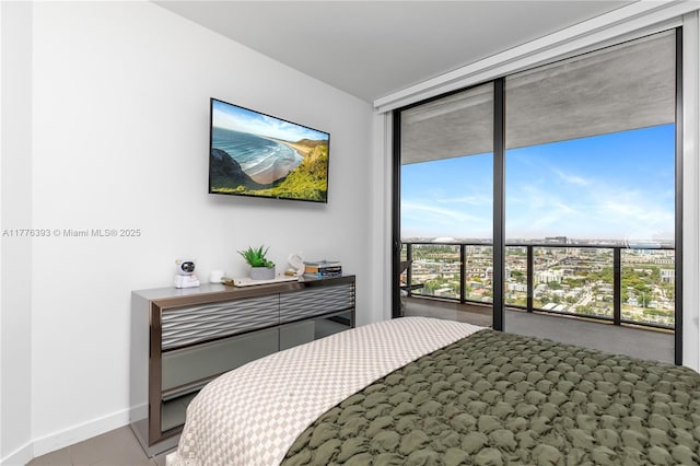 1600 NE 1st Ave Unit 2615, Miami, FL 33132 - bedroom featuring multiple windows, a wall of windows, and baseboards